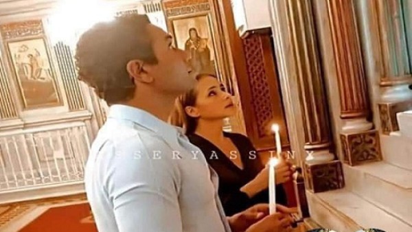 آسر ياسين ونيللي كريم يزوران دير المحرق بأسيوط ويشعلان الشموع أمام صورة السيدة العذراء